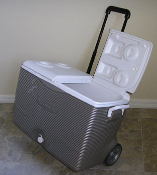 Cooler with extended handle and wheels for easy moving and draining