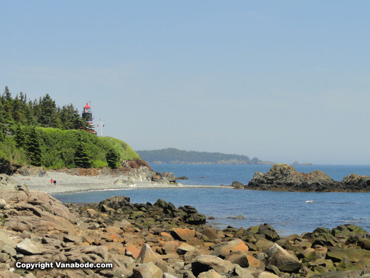 lighthouse from rocky beach in maine