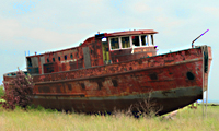 rusty boat on land